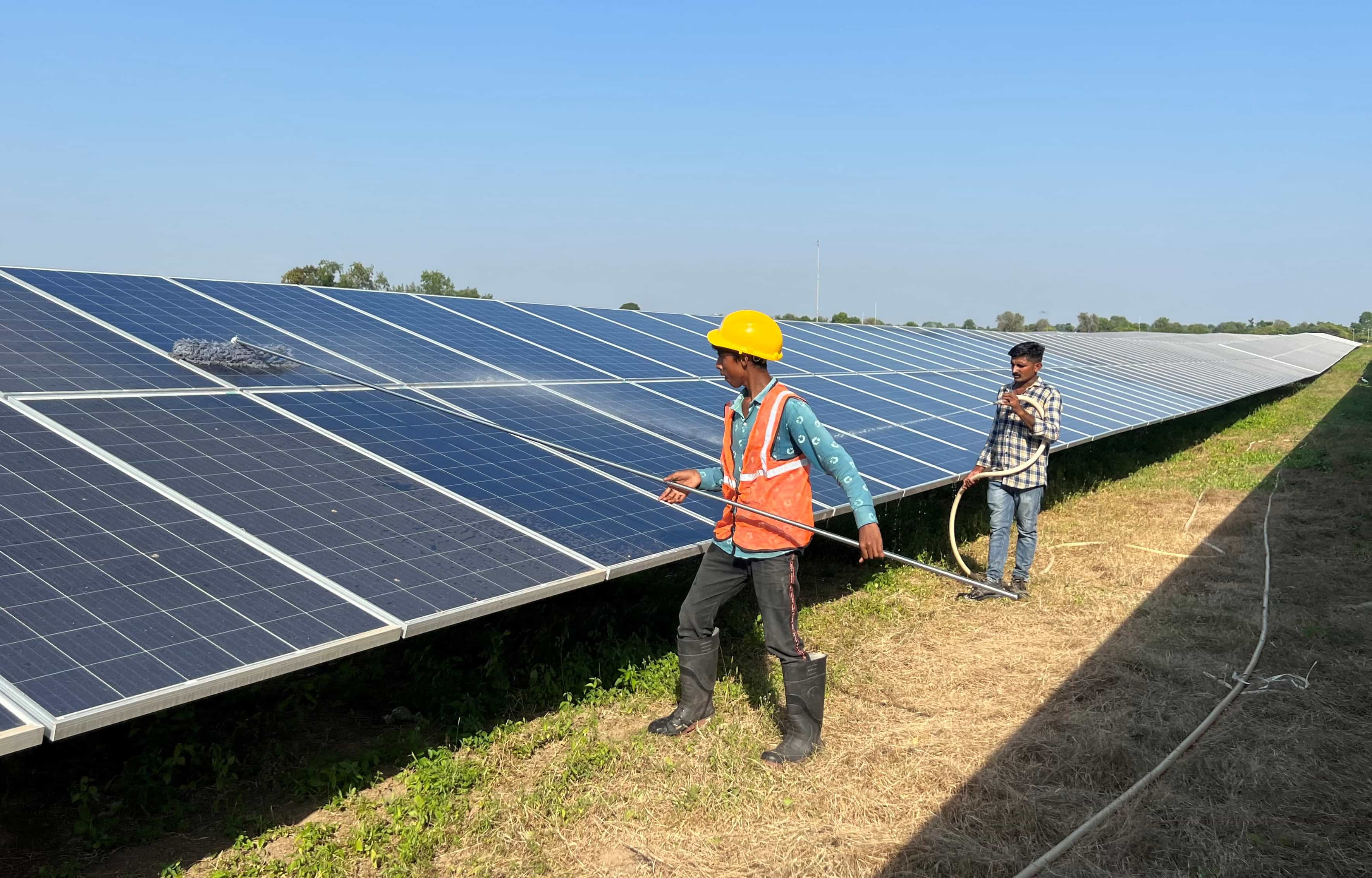 Workers-clean-panels-at-a-solar-park